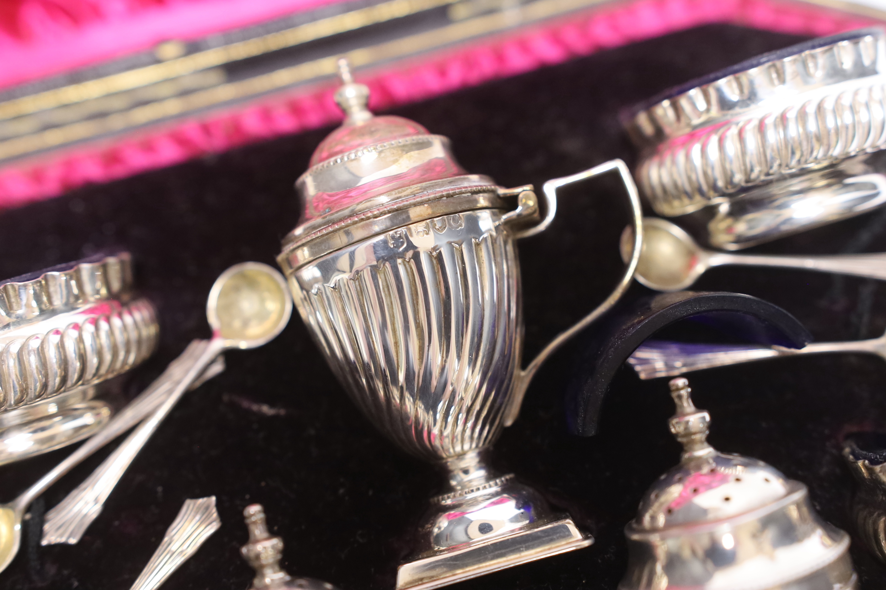 A cased late Victorian seven piece silver condiment set, Josiah Williams & Co Ltd, London, 1898, with five matching spoons.
